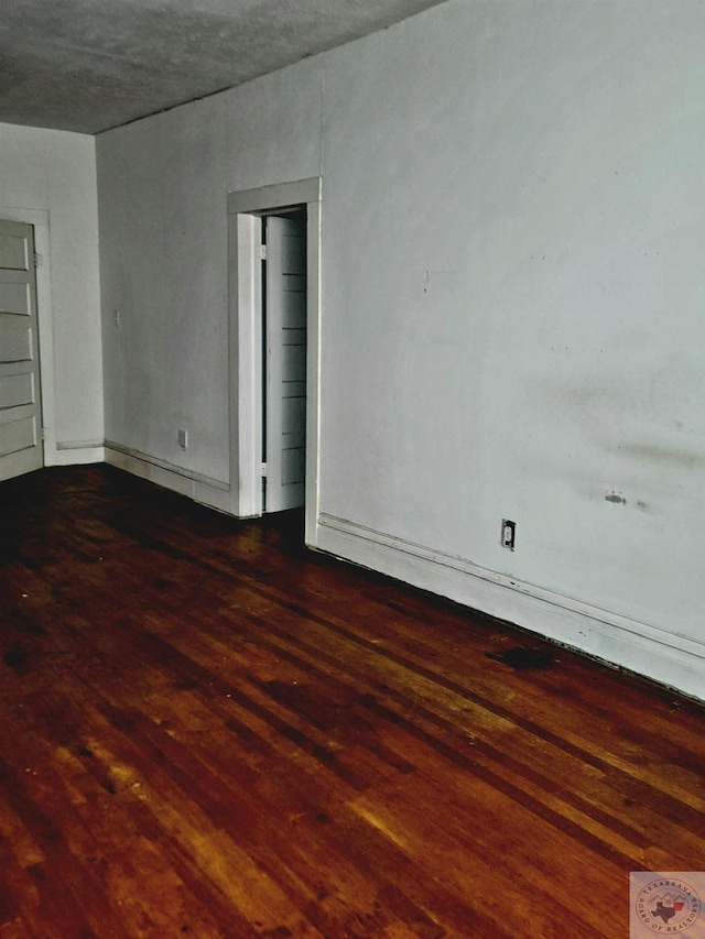 spare room with dark hardwood / wood-style floors