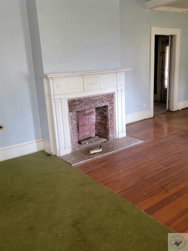 interior space with hardwood / wood-style flooring and a high end fireplace