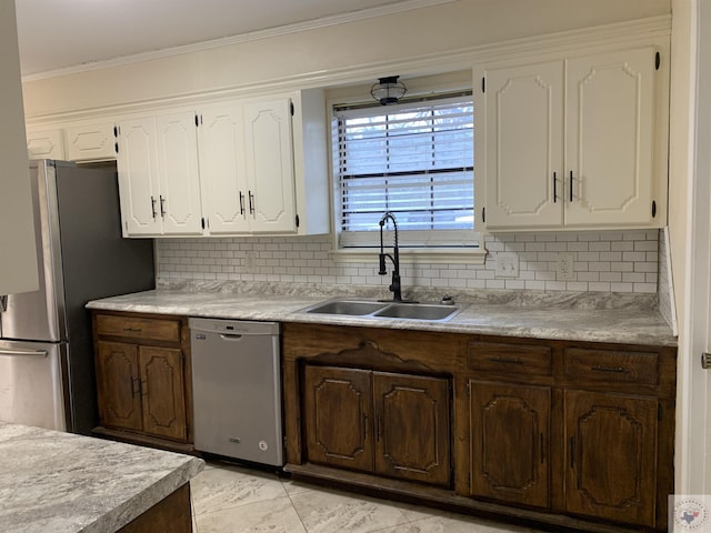 kitchen featuring a sink, stainless steel appliances, ornamental molding, and white cabinetry