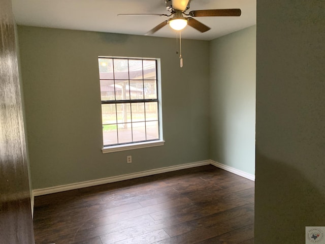 unfurnished room featuring a ceiling fan, baseboards, and wood-type flooring