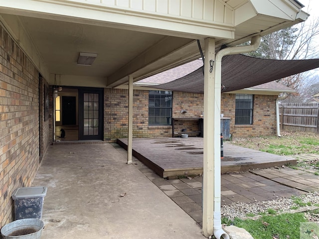 view of patio featuring a deck and fence