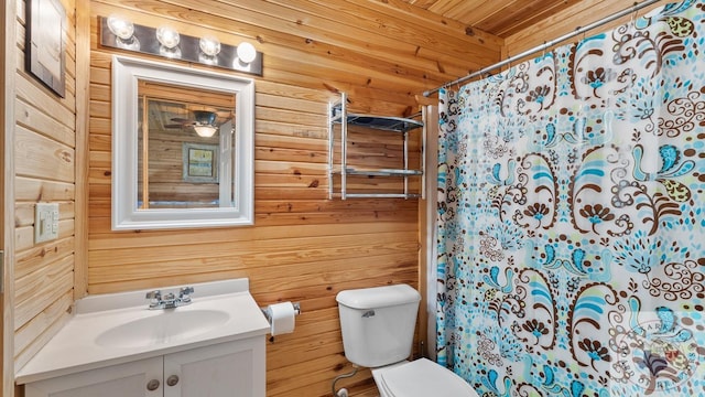 full bath featuring wood walls, vanity, and toilet