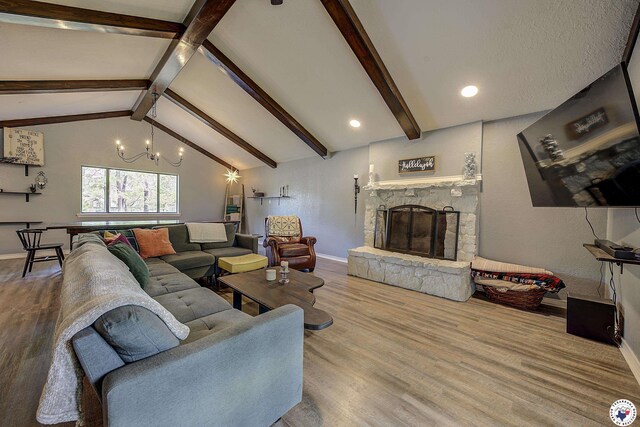 3009 Crestridge Dr, Texarkana, TX 75503 - living area with wood finished floors, vaulted ceiling with beams, baseboards, and a stone fireplace
