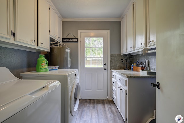 3009 Crestridge Dr, Texarkana, TX 75503 - laundry room with light wood-style floors, water heater, independent washer and dryer, cabinet space, and ornamental molding
