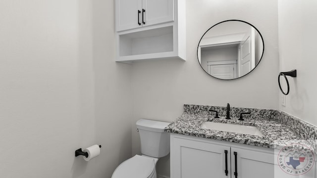 bathroom with toilet and vanity