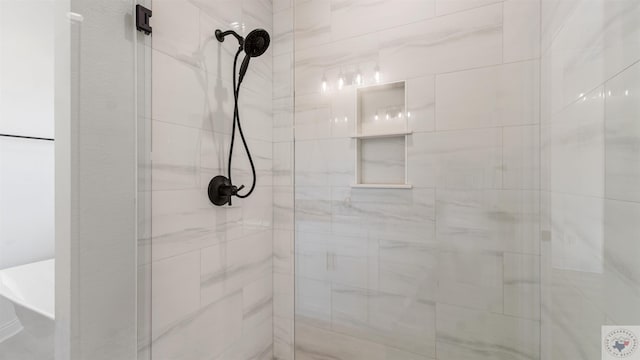 bathroom with a tile shower