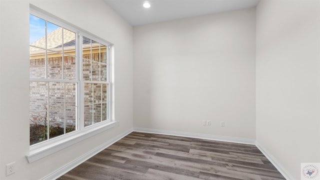 empty room with dark wood-type flooring