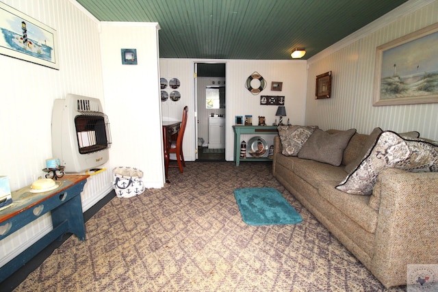 living room with crown molding, wood walls, and heating unit