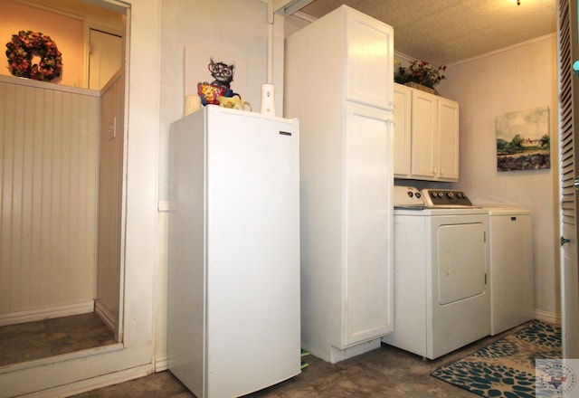 washroom featuring washing machine and dryer and cabinets