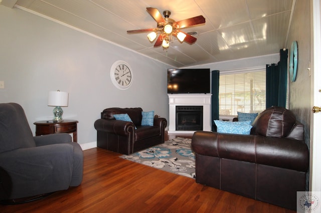 living room with hardwood / wood-style floors, ceiling fan, and ornamental molding