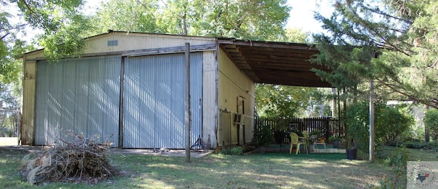 view of outbuilding featuring a yard