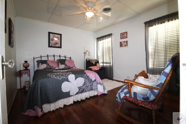 bedroom featuring hardwood / wood-style floors, multiple windows, and ceiling fan