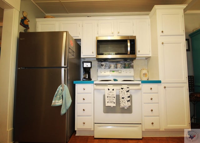 kitchen with white cabinetry, stainless steel appliances, and tasteful backsplash