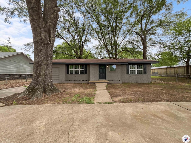 202 Main St, Hooks, TX 75561 - ranch-style house with brick siding, an attached garage, and driveway