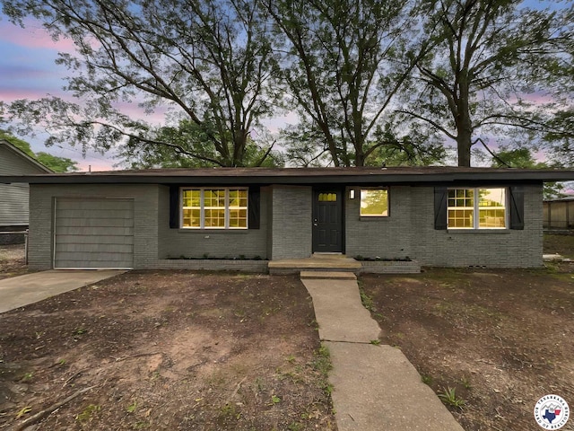 202 Main St, Hooks, TX 75561 - ranch-style house with brick siding, an attached garage, and driveway