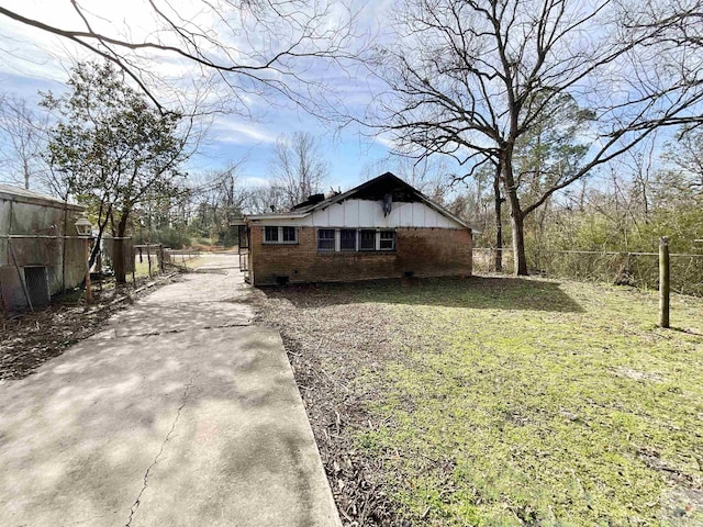 view of side of home featuring a yard