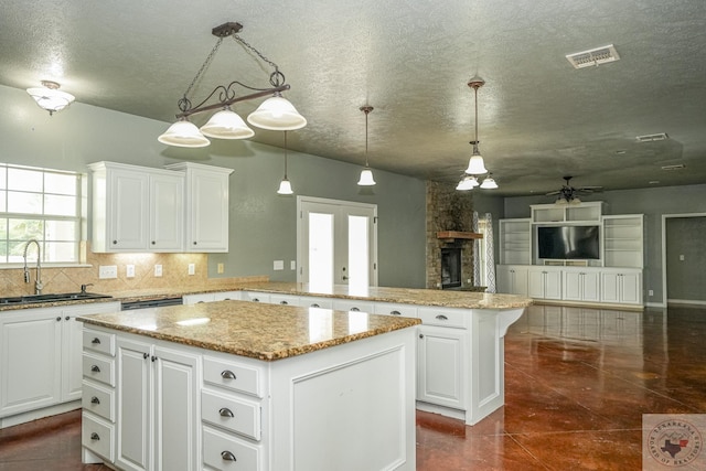 kitchen featuring white cabinetry, pendant lighting, and a center island