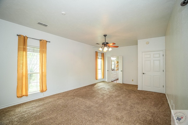 unfurnished room featuring ceiling fan and carpet flooring