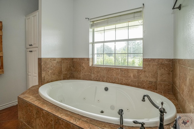 bathroom with a relaxing tiled tub