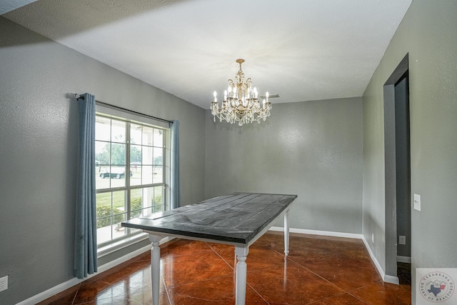 tiled dining room featuring an inviting chandelier and a textured ceiling