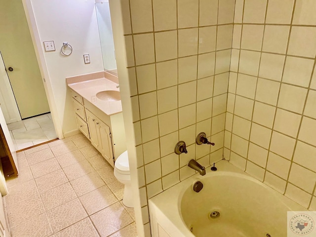 full bathroom featuring vanity, toilet, tiled shower / bath combo, and tile patterned flooring