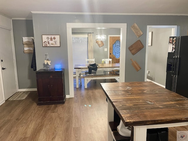 dining room with hardwood / wood-style flooring and ornamental molding