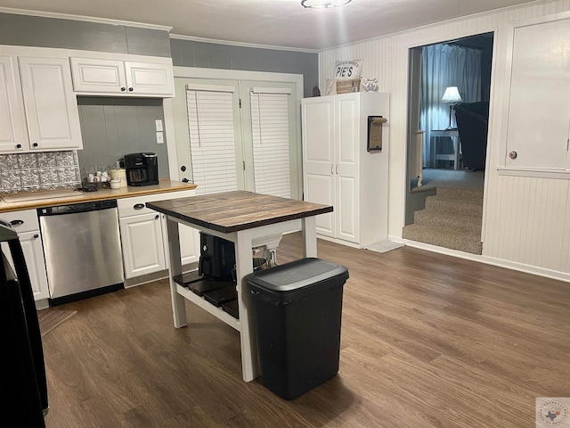 kitchen with crown molding, stainless steel dishwasher, butcher block countertops, and white cabinets