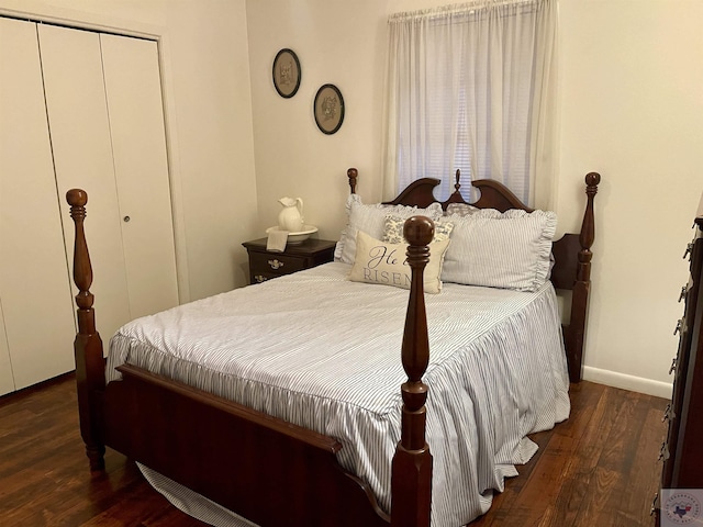 bedroom featuring dark wood-type flooring and a closet