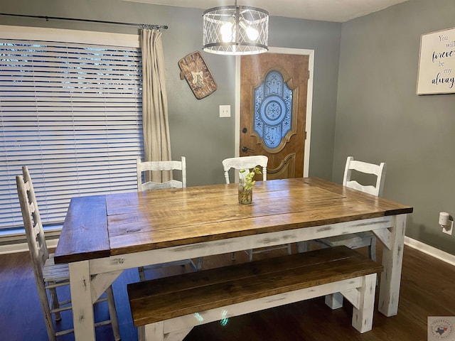 dining space featuring dark hardwood / wood-style floors and a notable chandelier