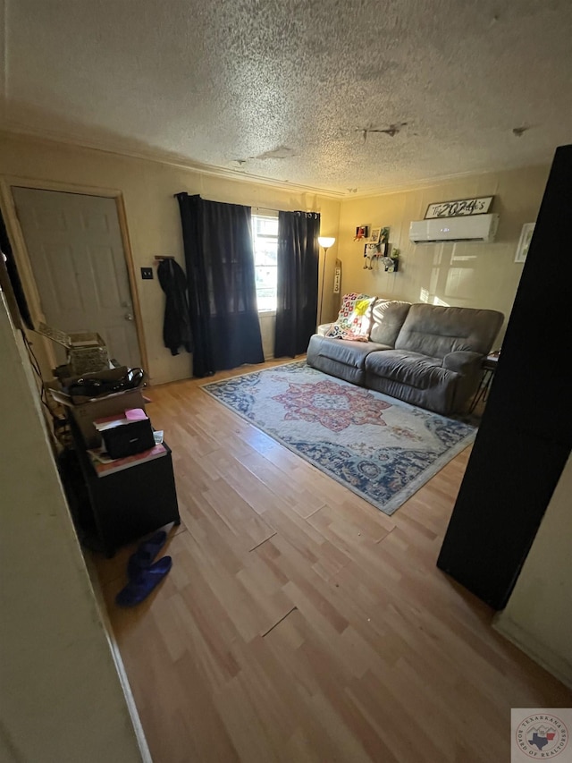 living room with hardwood / wood-style floors and a textured ceiling