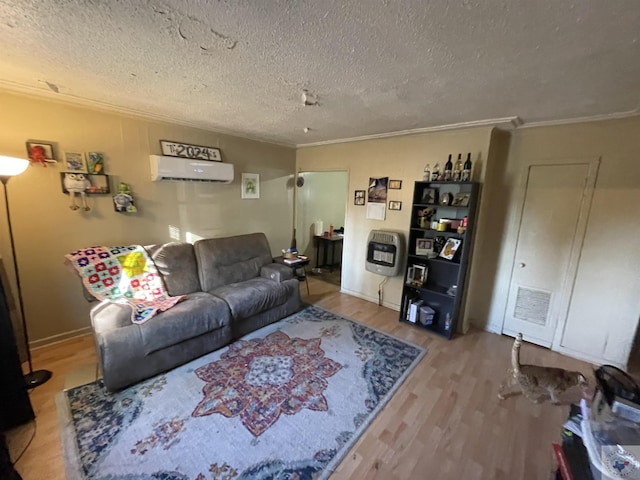 living room with a textured ceiling, a wall unit AC, hardwood / wood-style flooring, heating unit, and crown molding