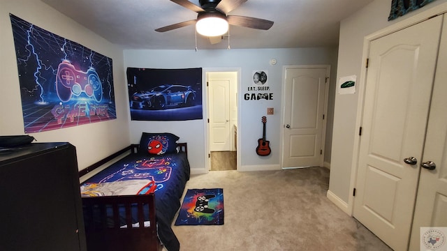 bedroom featuring light colored carpet and ceiling fan