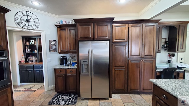 kitchen with appliances with stainless steel finishes, dark brown cabinets, crown molding, and light stone countertops