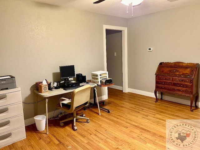 office with ceiling fan and light hardwood / wood-style floors