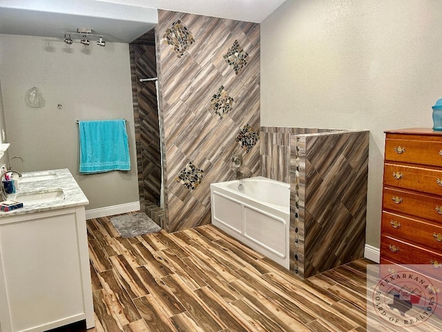 bathroom featuring a bathing tub, wood-type flooring, tile walls, and vanity