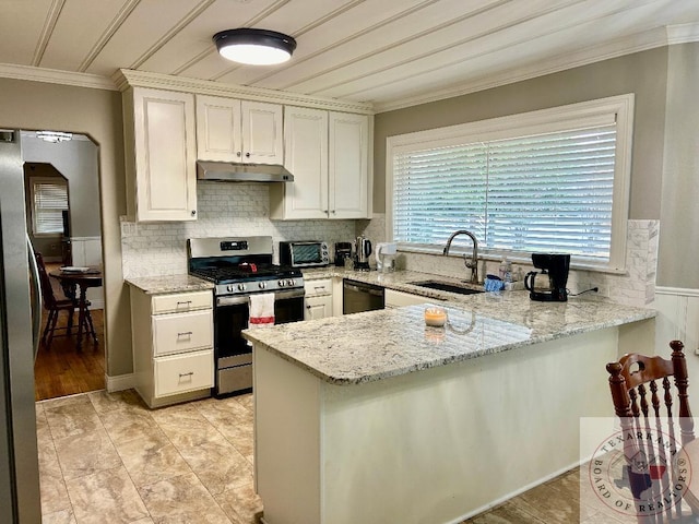 kitchen featuring sink, stainless steel appliances, white cabinets, and light stone countertops