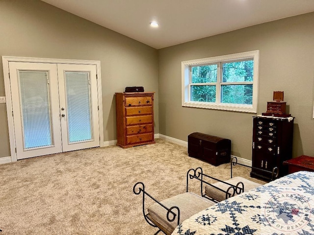 bedroom with vaulted ceiling, carpet flooring, and french doors