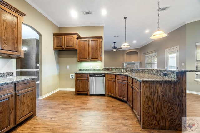 kitchen with stainless steel dishwasher, sink, decorative light fixtures, light hardwood / wood-style flooring, and dark stone counters