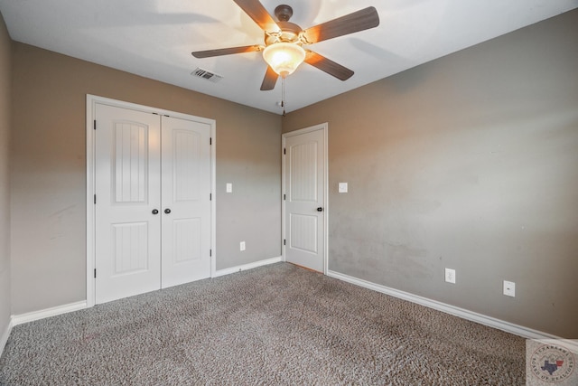 unfurnished bedroom with carpet, a closet, and ceiling fan