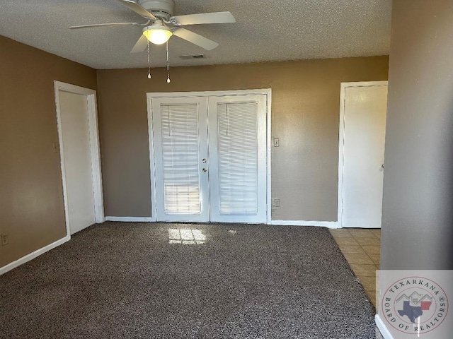 unfurnished bedroom with a textured ceiling, ceiling fan, and french doors