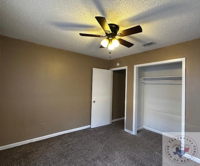 unfurnished bedroom featuring a closet, ceiling fan, dark colored carpet, and a textured ceiling