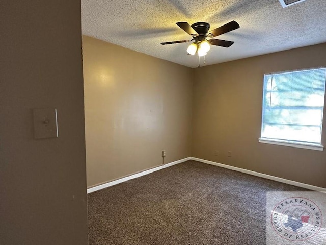 empty room featuring ceiling fan, carpet, and a textured ceiling