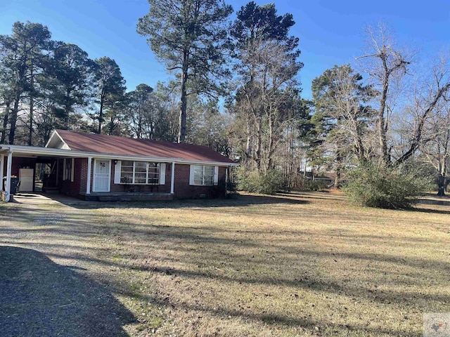 view of side of home with a yard and a carport