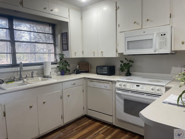 kitchen featuring white appliances, a textured ceiling, sink, white cabinets, and dark hardwood / wood-style floors