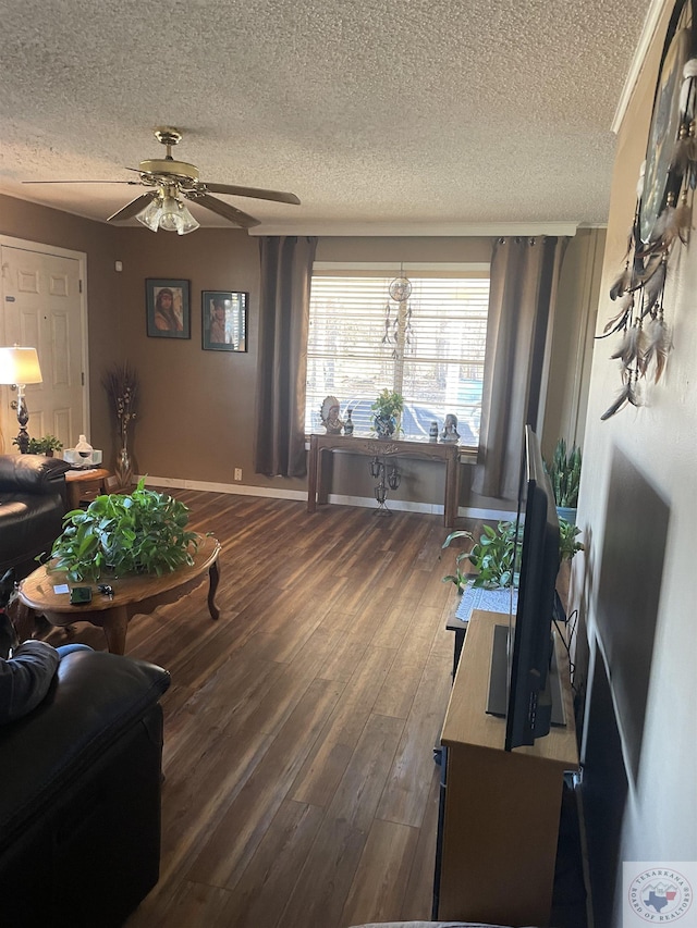 living room with ceiling fan, dark wood-type flooring, and a textured ceiling