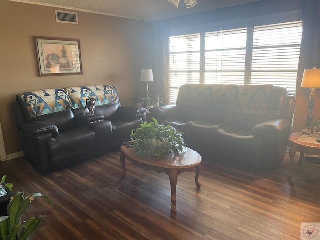 living room with crown molding and hardwood / wood-style floors