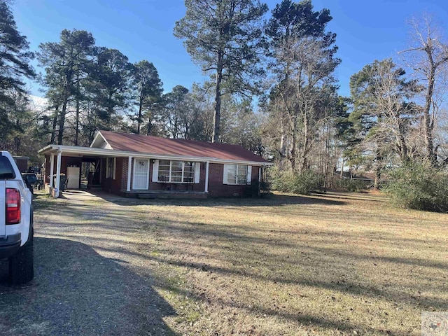 ranch-style home with a front yard and a carport