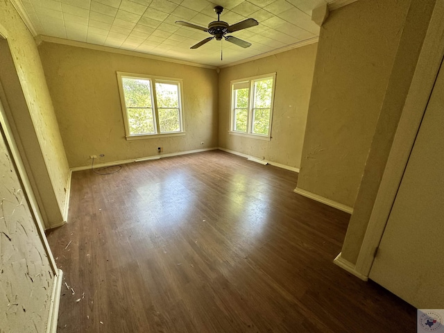 unfurnished room with crown molding, dark wood-type flooring, and ceiling fan