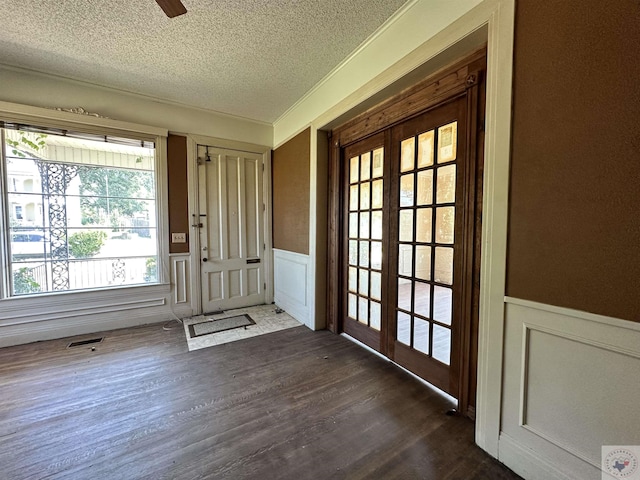 doorway featuring french doors, a textured ceiling, and dark hardwood / wood-style flooring