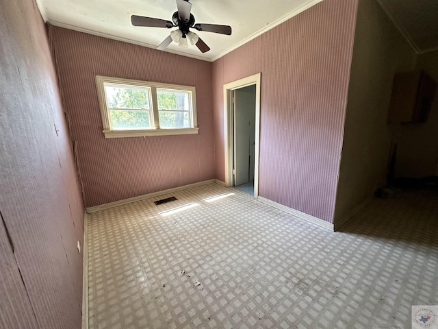 unfurnished room featuring ceiling fan and crown molding